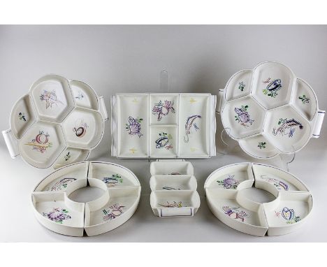 Six Poole pottery hors d'oeuvre dishes decorated with sea creatures and vegetables, by Truda Adams and other designers