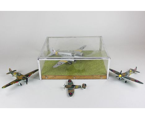 A set of three Corgi die cast model aeroplanes, a Hurricane and two Spitfire's, together with another model plane in a perspe