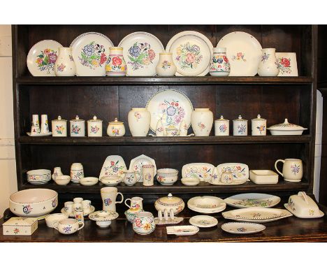 A large collection of Poole pottery including plates, vases, cruet sets, bowls, platters, ashtrays and other items