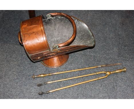 A copper coal scuttle, helmet shape, and two brass fire tools