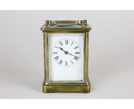 A brass and bevelled glass cased carriage clock, the white enamel dial with Roman numerals (a/f), 14cm