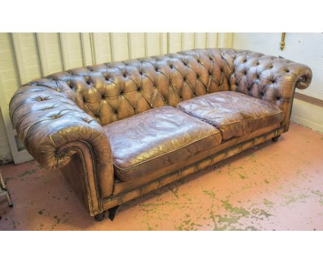 CHESTERFIELD SOFA, in buttoned brown leather, 105cm D x 235cm W x 75cm H.