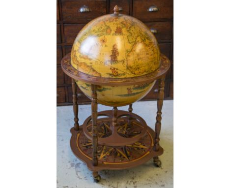 DRINKS CABINET, terrestrial globe form with hinged top in zodiac frame, 95cm H x 61cm D.