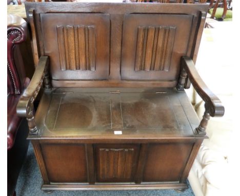 An oak linen-fold monks bench seat with lift seat