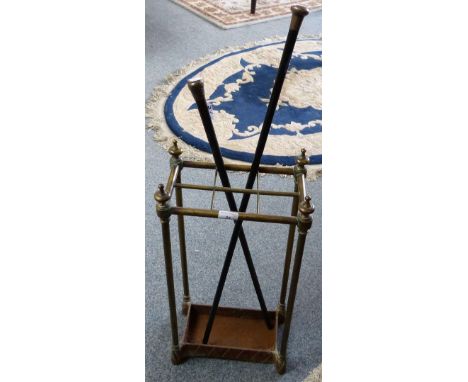 A brass stick stand together with two silver topped canes