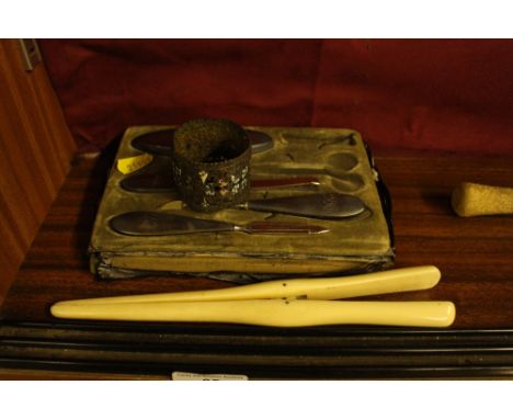 A cased silver part manicure set; a pair of ivory glove stretchers; and an enamel filigree work napkin ring