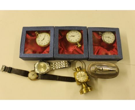 Three boxed pocket watches; a steel wrist watch; yellow metal wrist watch; a clock in the form of a lamp; and a plated cigare
