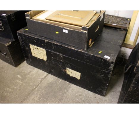 An old wooden and metal bound travelling trunk attached with old shipping line labels