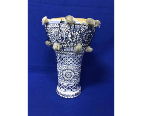 EARLY 20TH CENTURY EASTERN BLUE AND WHITE CERAMIC DRUMwith stylised floral motifs, with leather drum covering, 34cm high