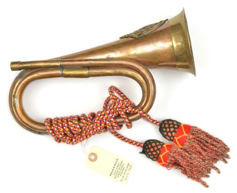 A brass and copper bugle, with applied A&amp;S Highlanders badge, coloured cords and tassels. GC (mouth piece missing)       