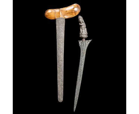 A Balinese dagger kris. Straight blade 40cms with distinctive pamor, silver hilt embossed as Bima, ring set with pastes, in i