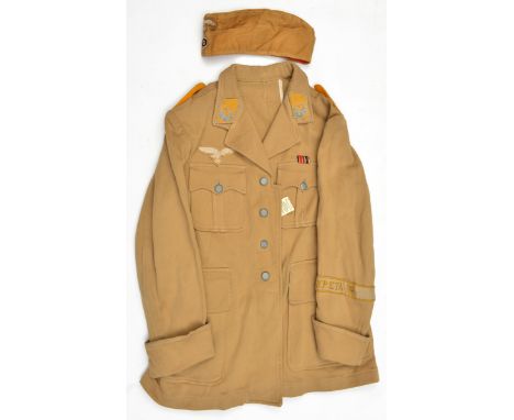 A Third Reich style Luftwaffe tropical tunic, with collar patches and epaulettes to a Leutnant in the flying section, and emb