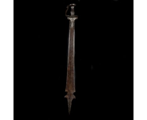 A South Indian sword khanda. Broad DE blade 88.5cms swollen towards the partizan-shaped tip, iron hilt with broad knuckle gua