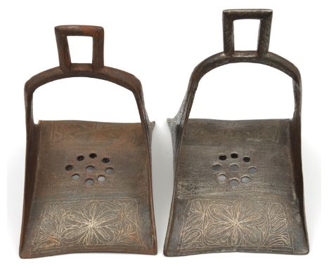 A pair of North African iron stirrups. 20th century, 20cms, of conventional form with integral suspension brackets, curved re