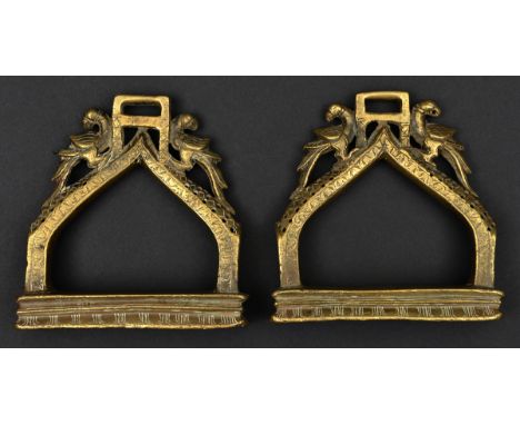 A pair of South Indian cast brass hollow stirrups. Probably 19th century, each bow engraved and pierced, with a pair of confr