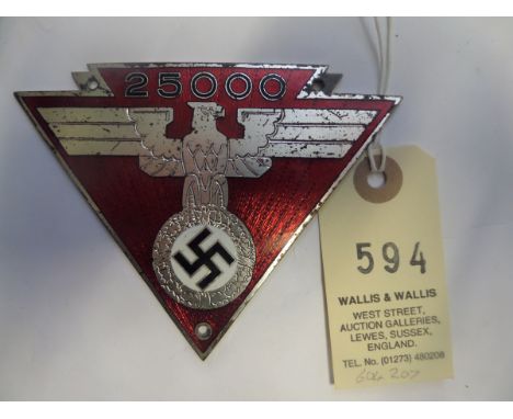 A Third Reich car dashboard (?) triangular plaque,  silver plated eagle and swastika on red enamel ground with black enamel “