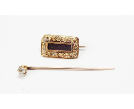 A small yellow metal oblong panel mourning brooch - sold with a white sapphire set yellow metal stick pin