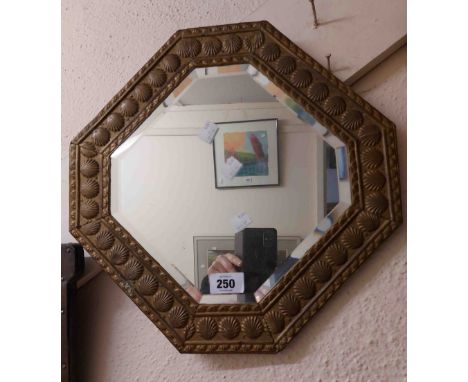 A vintage embossed brass decorated octagonal wall mirror with bevelled plate - sold with an antique gilt framed oval wall mir