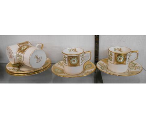 A set of four Royal Crown Derby green Derby panel coffee cans and saucers - sold with a spare saucer