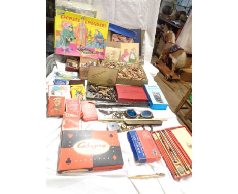 A box containing a quantity of assorted collectable items including card games, checkers, floating dairy thermometer, etc.