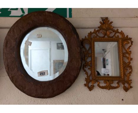 A small rustic wood framed bevelled oval wall mirror - sold with a vintage gilt metal framed ornate similar