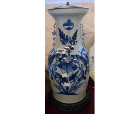 A 19th Century Chinese porcelain vase of baluster shape with applied dog form handles and blue hand painted decoration depict