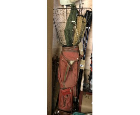 An old golf bag containing a vintage two section split cane boat rod - sold with an Olympic 2080 Spinning fishing rod in canv