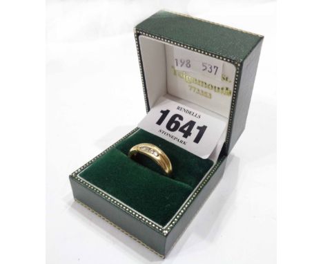 A marked 9c yellow metal ring, with eight channel set tiny diamonds - size P - boxed