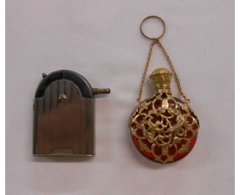 A bag containing a gilt metal mounted ruby glass scent bottle and a Kaschte 37 patent petrol lighter