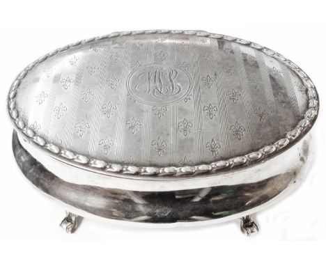 A 12.5cm silver oval ring box with initials and other decoration to hinged lid, set on quadruple scroll feet - Birmingham 190