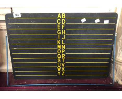A vintage child's easel blackboard with yellow printed alphabet and lines