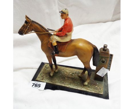 An old cold painted spelter figural table lighter depicting a racing horse and jockey with Strike-A-Light lighter to side