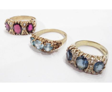 A 375 (9ct.) gold ring, set with three blue topaz stones - sold with a similar garnet and white paste ring and an unmarked ye