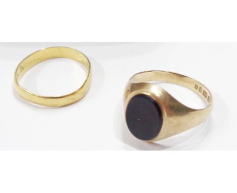 A 375 (9ct.) gold black onyx panel ring - sold with a 22ct. gold wedding band - sizes N 1/2 and M respectively