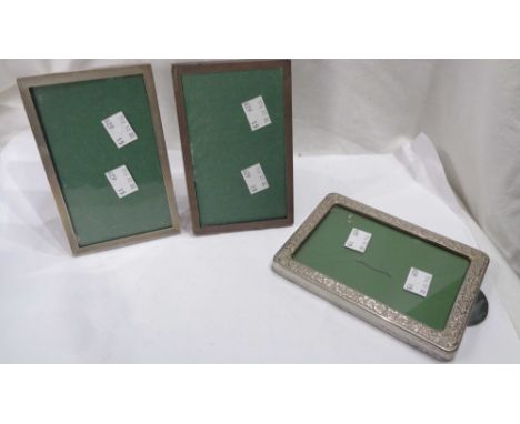 A pair of small silver fronted oblong photograph frames with polished wood easel backs and engine turned decoration - sold wi