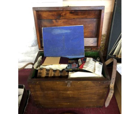 A vintage magician's rabbit transportation box containing a quantity of magic tricks and related items