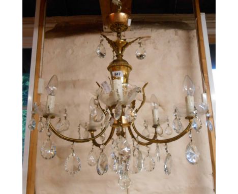 An old five branch chandelier, the gilt brass frame with acanthus leaf decoration and Murano crystal lustres and sconces