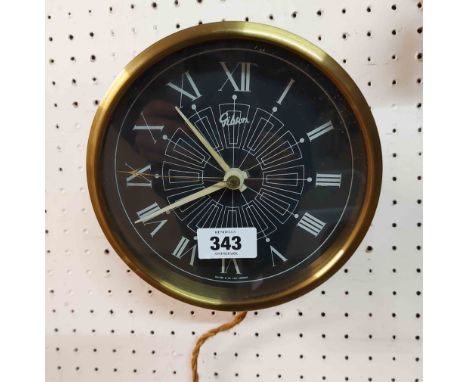 A vintage brassed metal cased Gibson electric wall timepiece - sold as a collectors' item