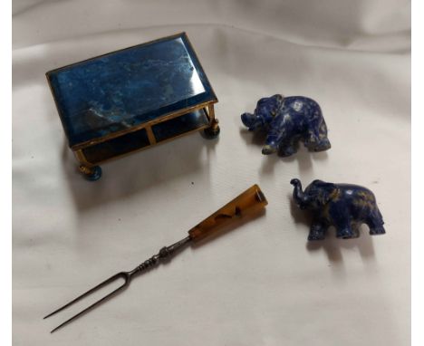 A bag containing a 19th Century lapis lazuli mounted gilt metal casket (glass missing), two carved lapis elephant figurines a