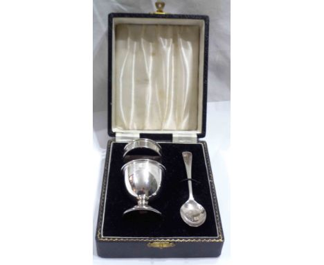 A boxed silver egg cup, napkin ring and spoon set - Birmingham 1961 - no initials