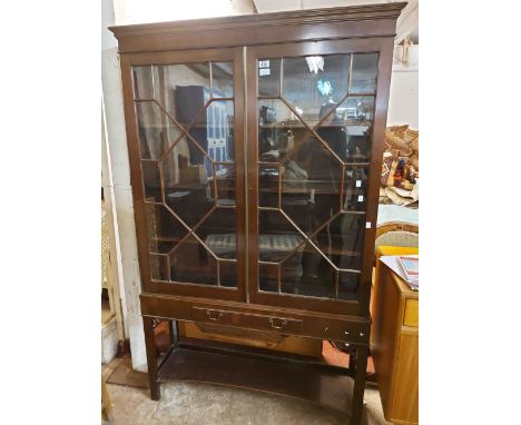 A 1.09m 19th Century mahogany book cabinet with shelves enclosed by an astragal glazed panel door, set on a base with frieze 