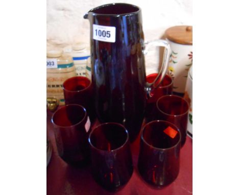 A vintage ruby glass lemonade set comprising jug and four tumblers