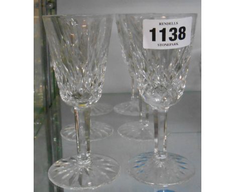 A set of six Waterford Crystal wine glasses with tall bucket bowls and faceted stems