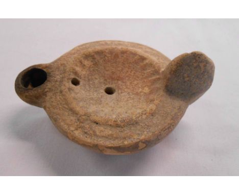 A Roman pottery oil lamp of antiquity