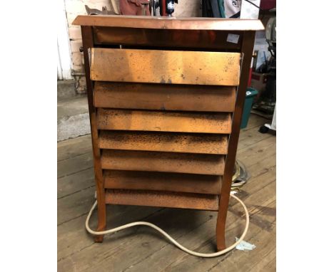 An old electric light bulb radiance heater of copper louvered form - for decorative use only