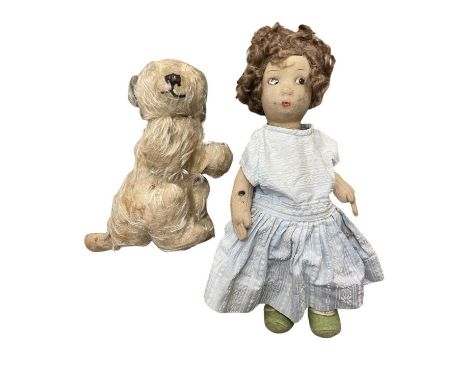 A vintage cloth body doll and dog soft toy.