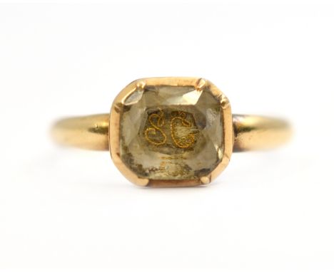 An 18th century memorial ring with initials set behind crystal, tested to high ct, size P, approx 3gms