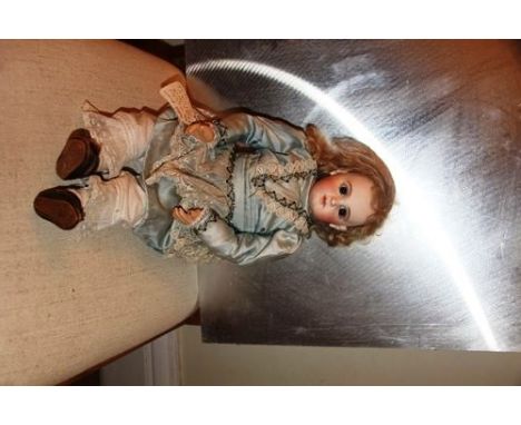 Jumeau bisque head doll. Head incised E.J. The doll has pale bisque with closed mouth, brown paperweight eyes, pierced ears, 