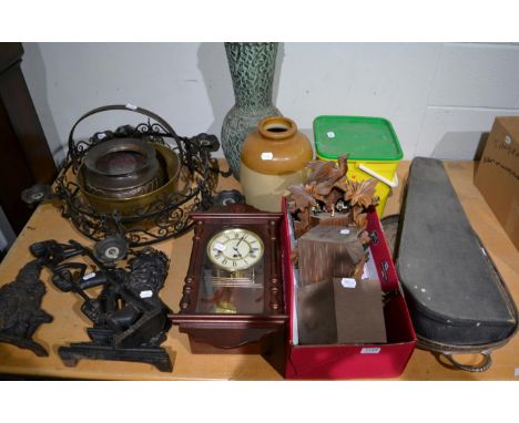 A mixed group of items including three cuckoo clocks, modern banjo, two Victorian cast iron fire ornaments (Punch and a seate