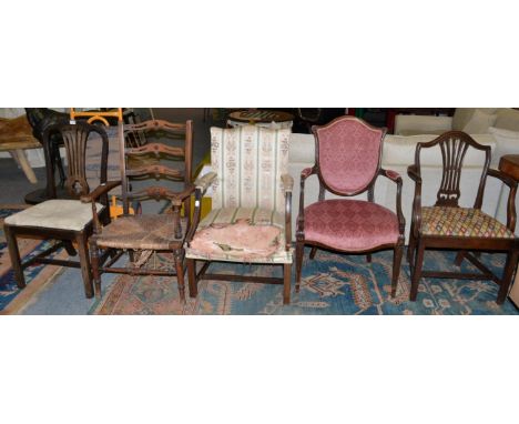 Five chairs comprising a rush seated ladder back armchair; three late 19th/early 20th century mahogany armchairs; and a 19th 